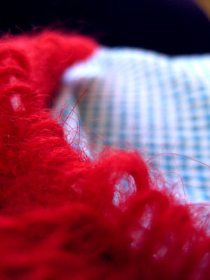Red fuzzy knitting with blue gingham dress