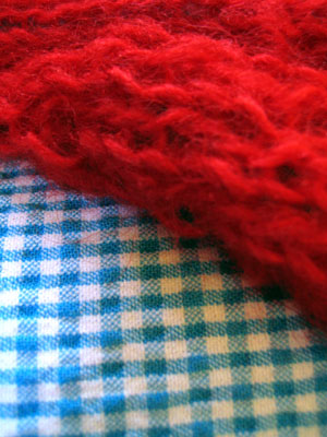 Red fuzzy knitting with blue gingham dress